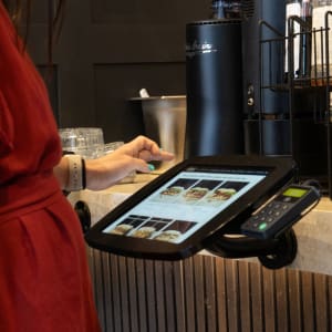 Lady in red ordering from a kiosk