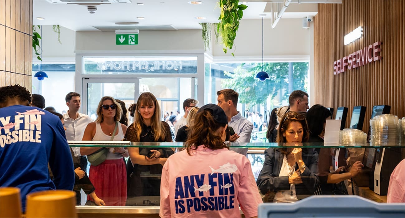 Busy kitchen and customers in Honi Poke