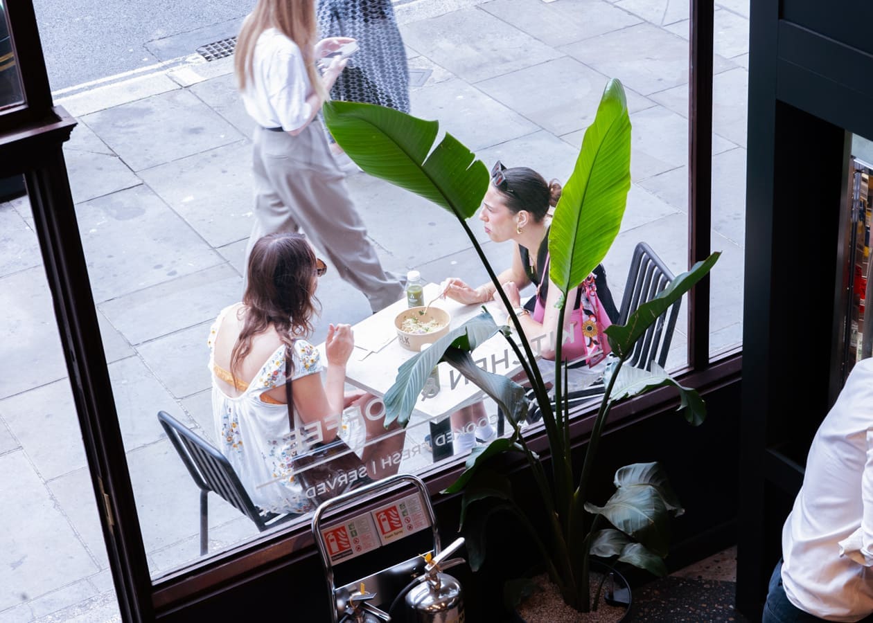 customers talking outside a restaurant window