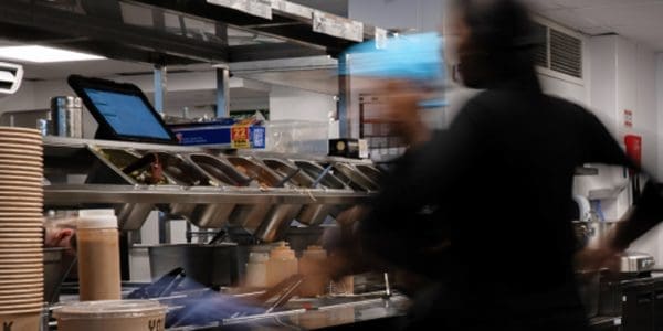 Two people working in a busy kitchen