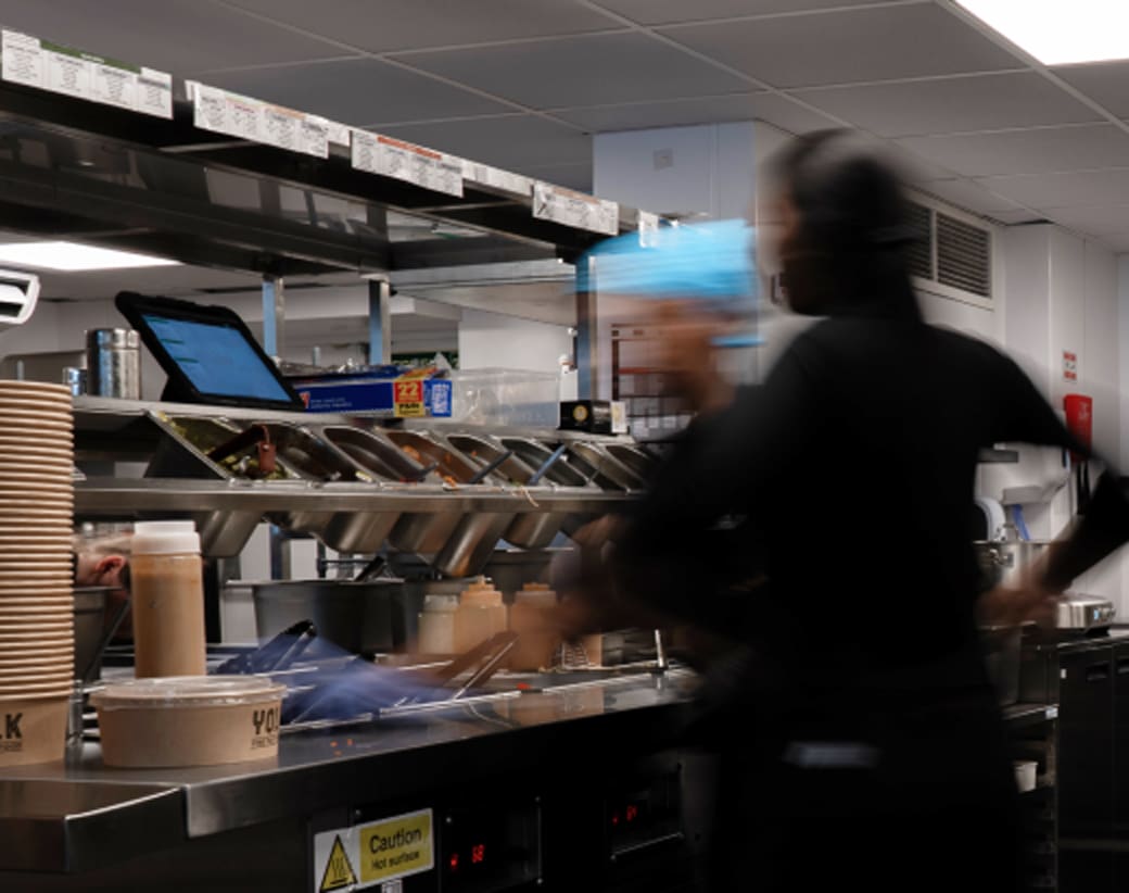 Two people working in a busy kitchen