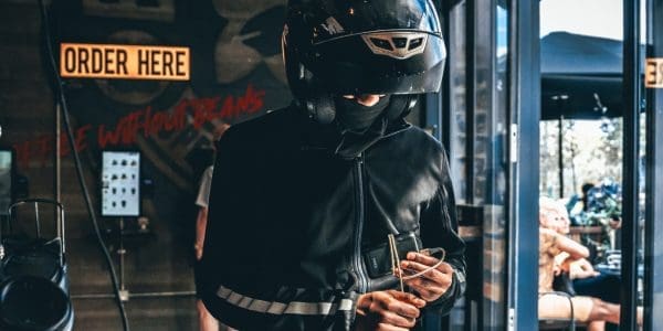 delivery person in a crash helmet picking up an order