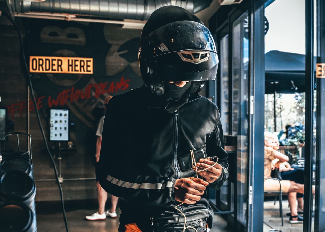 delivery person in a crash helmet picking up an order