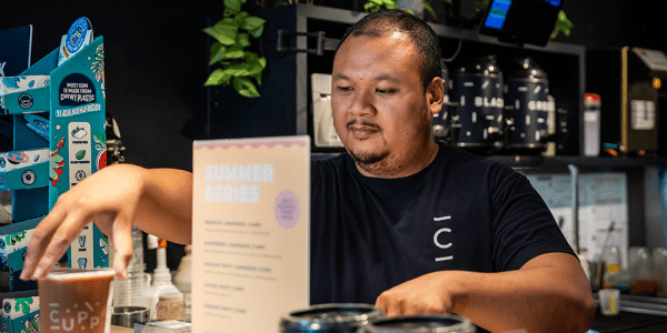 a man working in CUPP serves a customer a drink