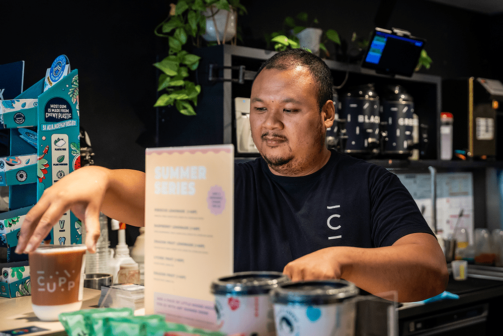 a man working in CUPP serves a customer a drink