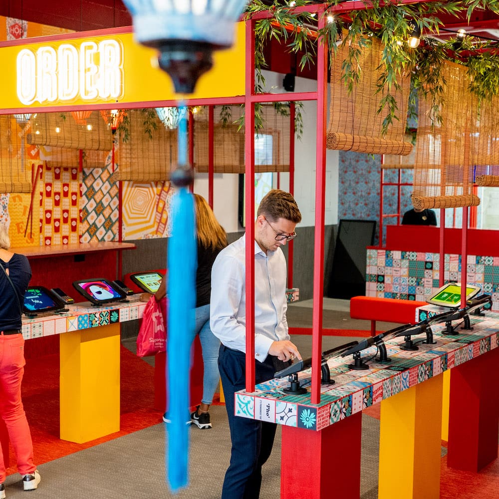 Man ordering food from Hop vietnamese kiosks