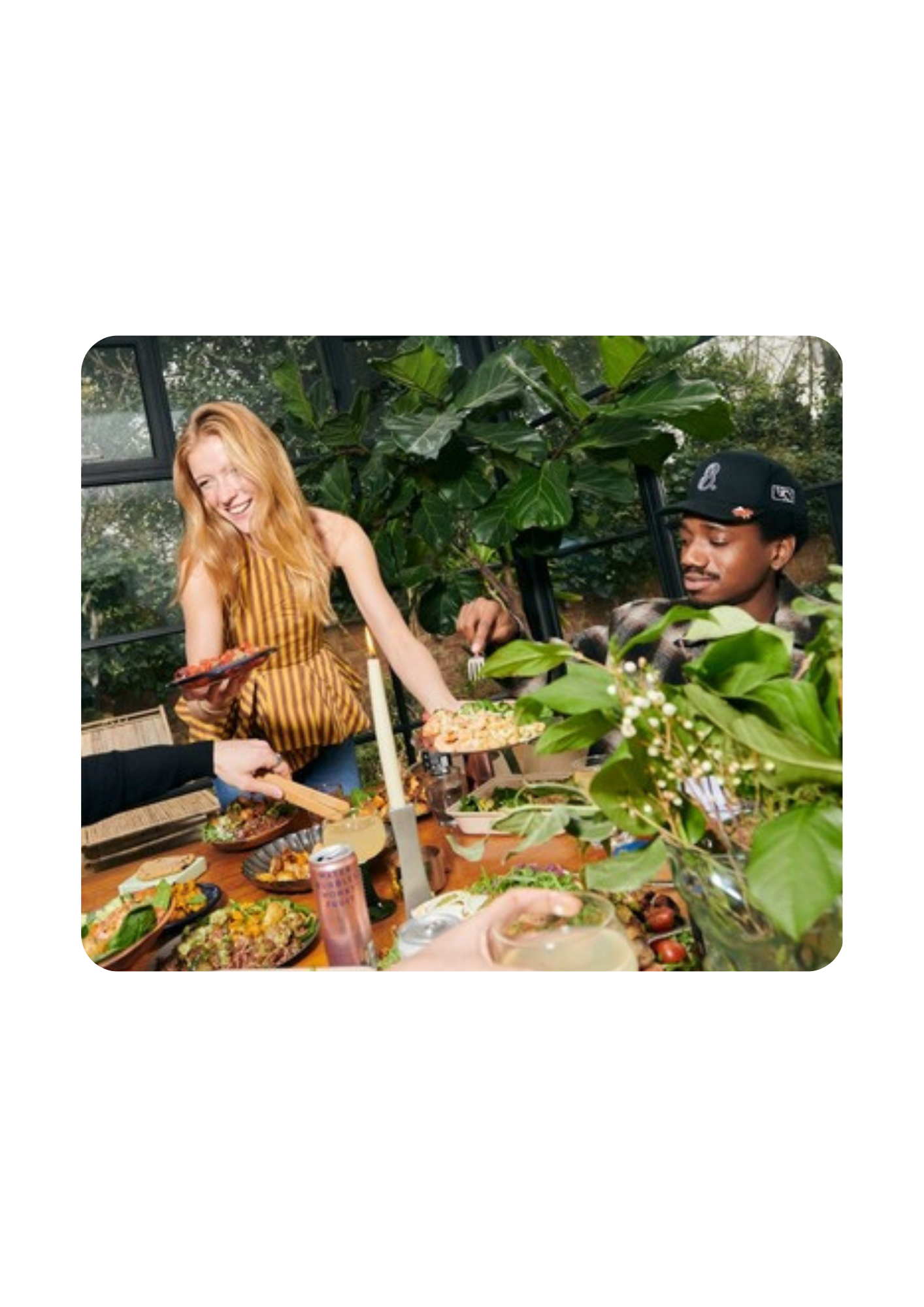A woman laughing while serving salad at The Salad Project